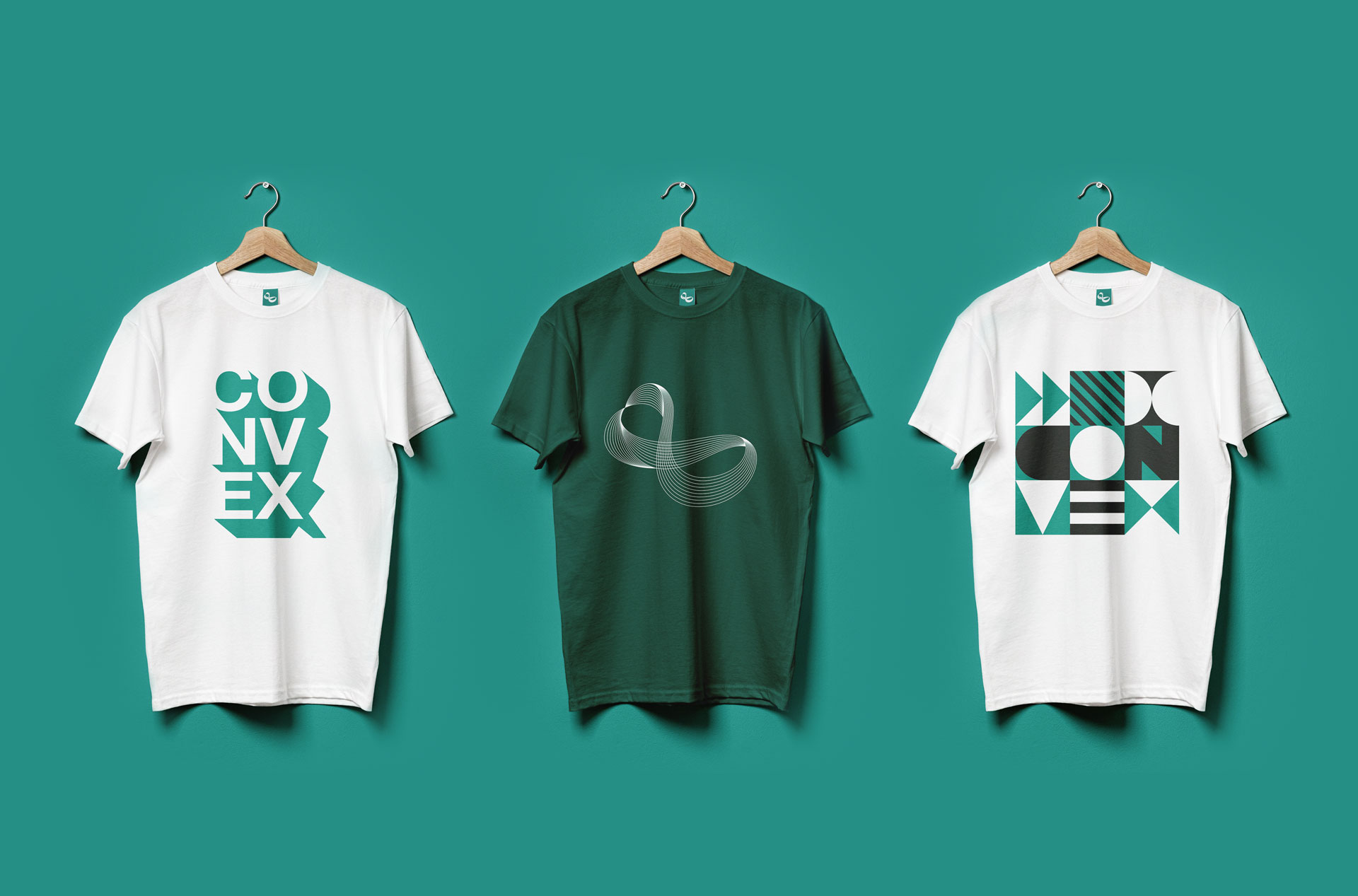 Three t-shirts hanging, two white and one green. All have modern designs