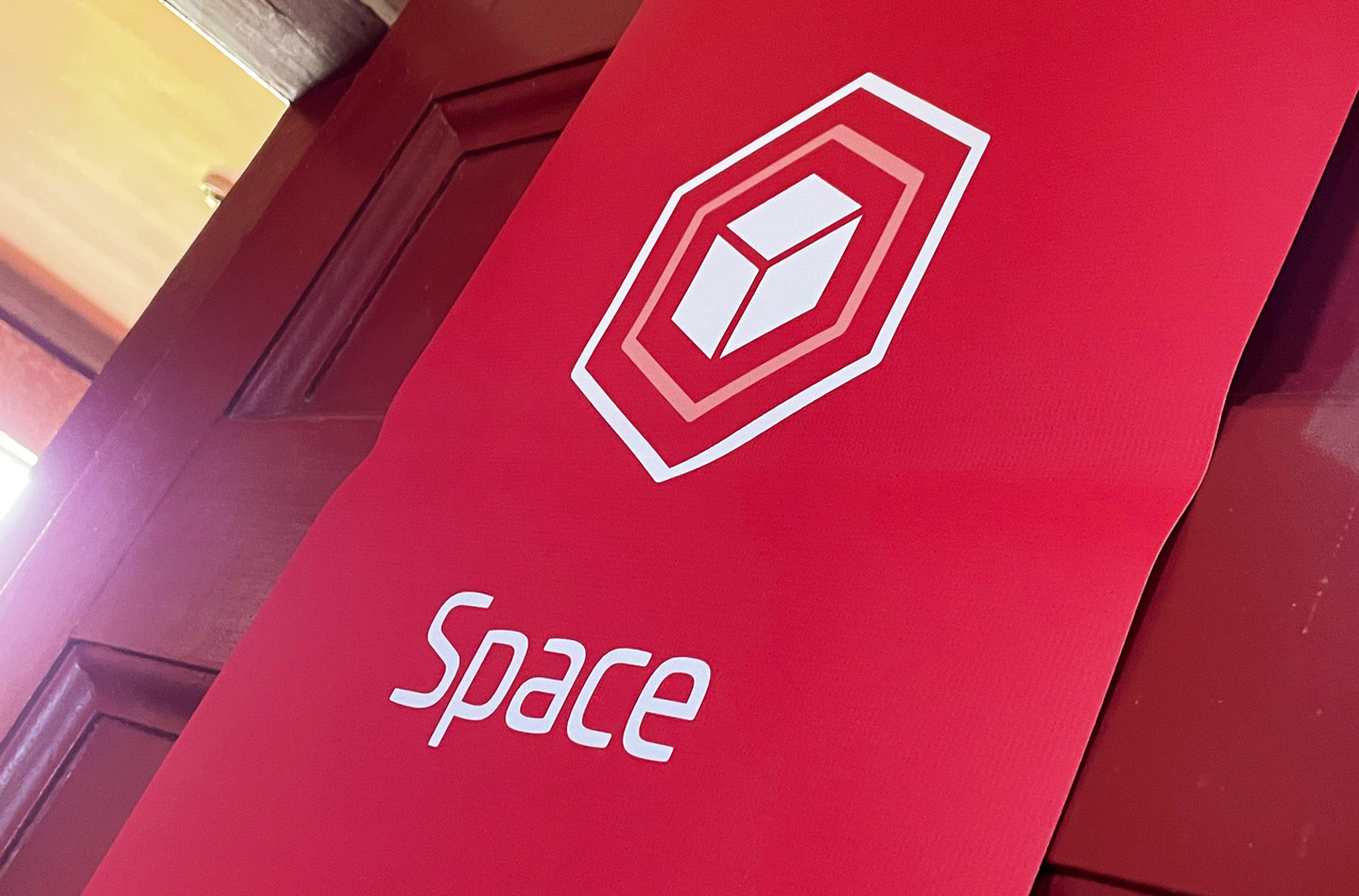 Convex United red door signage with an icon and the text space